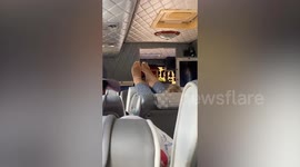 Rude, blonde-haired tourist puts her feet on passenger's head rest in coach in Thailand