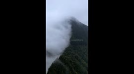 Spectacle of Rain Clouds Intercepted by Mountain Peaks on Yunnan Plateau, Southern China