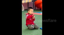 Adorable Chinese toddler's comical reaction to sour orange delights kindergarten teacher