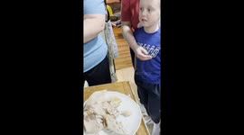 Boy Thinks Cooked Turkey Neck Is Something Else