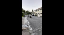 Friends race electric go-karts through streets outside their homes