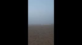 Fog blankets Valencia's Cabanyal Beach in daylight mystery