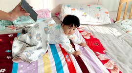 Snoozing toddler springs to life when parents play his favourite song