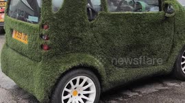 Grass turfed Smart car. A prize winning drivable garden feature. Helston, Cornwall UK