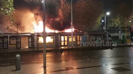 Fire and smoke billows out of a Luas tram as disorder continues in Dublin, Ireland