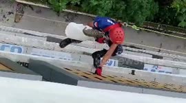 Superhero firefighters save cat stuck in a hole on the 4th floor of a building in Padang, Indonesia