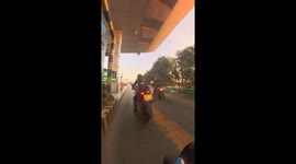 Motorcyclist narrowly escapes injury as barrier strikes helmet: caught on camera