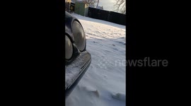 Man Prepares His Car for Winter With A Warm Hat in Borisov, Belarus