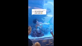 Terrifying moment professional mermaid's tail gets STUCK underwater in mall tank