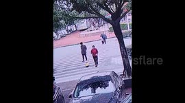 Quick-thinking passerby rescues toddler falling from toy car on busy road