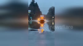 Cars Navigate Flooded Roads Amidst Relentless Rainfall in Oregon, USA