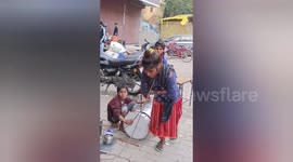 A girl on the  Praygraj street is showing her art activities  bends a hard iron with her neck very easily
