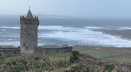 People watch Atlantic swells in Doolin, Ireland during Storm Elin