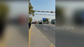 Man chases out of control car circling around another vehicle