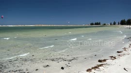 Daredevil kitesurfers (kiteboarders) on a windy day - jumping, landing and crashing.