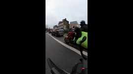 Group of motor cyclists on festive ride, riding dangerously, weaving, revving and jumping red lights.