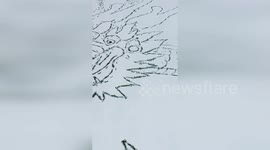 Chinese artist creates jaw-dropping dragon by walking over fresh snow