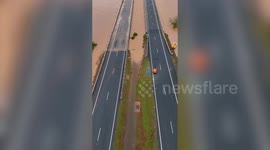 Major flooding leaves Australian highway completely submerged - and infested with CROCS