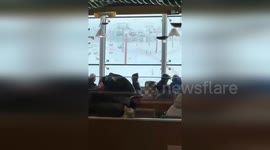 Strong wind shakes ski slope cable cars as tourists cling to seats