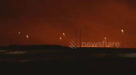 The new volcano eruption in Iceland. Cars passing on the main road with the lava in the background.