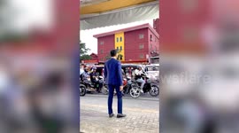 Well-dressed man in formal suit bursts into Michael Jackson moves outside shop