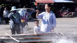 Tourists make the most of hot spring in Thailand by cooking their eggs
