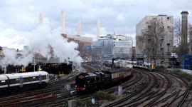 A journey through nostalia as steam trains pass under stunning backdrop of Battersea Power Station with festive illuminations