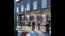 Close-up of protesters, police and placards in Iceland
