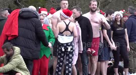 Swimmers take a Christmas Day dip in Blackroot Pool at Sutton Park in Birmingham, UK