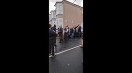 Palestinian flags being removed from lamp posts.