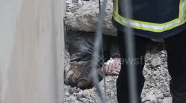 Footage of a man being rescued from rubble in Kharkov