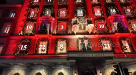 Londoners pack the streets looking at Christmas decorations on the outside of London stores