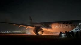 Japan Airlines plane in flames on runway at Tokyo's Haneda airport