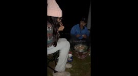 Fireworks explode around woman as she welcomes New Year at campsite in Thailand