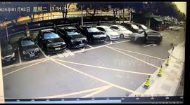 Out-of-control car narrowly avoids collision with man in parking lot in China