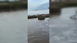 English Pub Owner Enjoys Pint In Flood Water in Severn Stoke, Worcestershire, UK