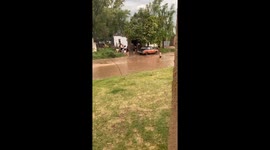 Local residents play lighthearted prank in flood waters amidst storm aftermath