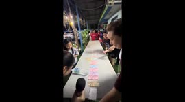 Family plays money bottle rolling game for New Year party