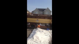 Garbage Man Shoveling Snow Into The Truck