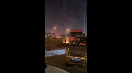 Firefighters Guard Beside Crowds Setting Off Fireworks on New Year's Eve in China