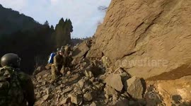 Soldiers trek through rubble-covered mountain to transport earthquake aid in Japan
