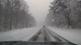 Vehicle skids on snowy road and narrowly avoids police car in Pelham, Massachusetts