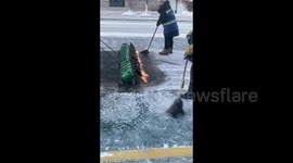 Sanitation workers ignite flames to tackle icy streets amidst freezing temperatures in China