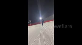 Snowboarder glides flexibly down a slope and dances spectacularly at the same time in Altai, China