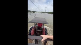 Tourists transported to hotel on tractor through crocodile-infested floodwater in Sri Lanka