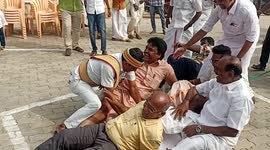 Local mayor and officials fall down after a rope cutdown unexpectedly in a Fun sport in south India