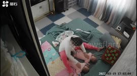 Exasperated Chinese mum lulls stubborn twins to sleep by pushing their heads on bed
