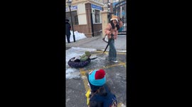 Children sit in inflatable sleds to travel safely with parents in China