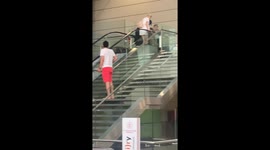 Woman falling in airport falling escalator