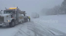 Tow Trucks Brave Elements to Salvage Stranded Trucks on Icy NYS Thruway in Albany, NY, USA